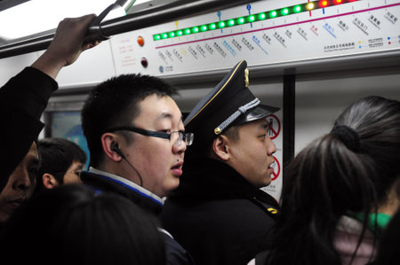 BEIJING - MARCH 11:Crowded scene of Beijing's subway during rush hour on March 11 2009 in Beijing,China.It's transports about 7 million people every day, which is about the total population of Cairoのeditorial素材