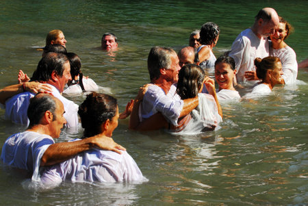 TIBERIAS - MAY 18:Christian pilgrims during mass baptism ceremony at the Jordan River in North Israel on May 18 2009.In Christian tradition, Jesus was baptised in the River Jordan by John the Baptist.のeditorial素材