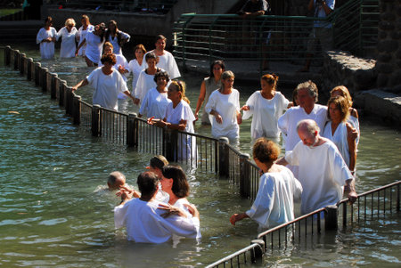 TIBERIAS - MAY 18:Christian pilgrims during mass baptism ceremony at the Jordan River in North Israel on May 18 2009.In Christian tradition, Jesus was baptised in the River Jordan by John the Baptist.のeditorial素材