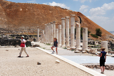 BEIT SHEAN,ISR - JUNE 17:Visitors walks under Pillars in Ancient Beit Shean on June 17 2009.Beit She'an is one of the most ancient sites in Israel: it was first settled 5-6 thousand years ago.のeditorial素材