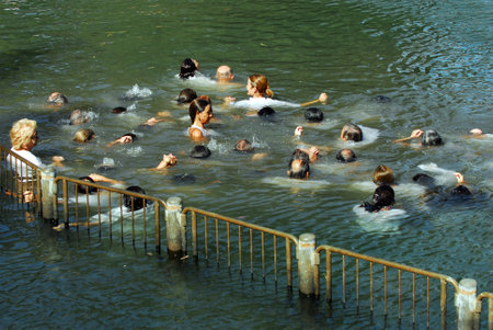 TIBERIAS - MAY 18:Christian pilgrims during mass baptism ceremony at the Jordan River in North Israel on May 18 2009.In Christian tradition, Jesus was baptised in the River Jordan by John the Baptist.のeditorial素材