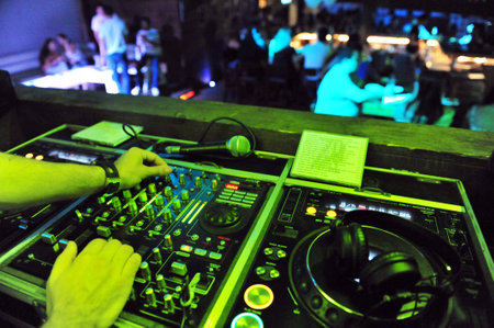 NETIVOT - AUGUST 24: Dj mixing in a night club on August 24 20in Netivot, Israel. Studies have shown that the average person will spend three to four hours per weekend in a Nightclub.のeditorial素材