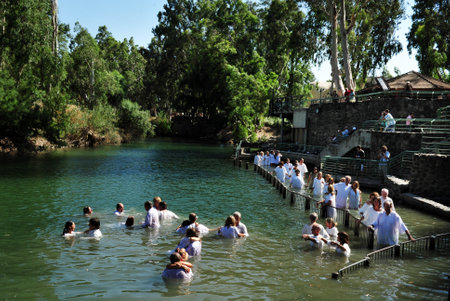 TIBERIAS - MAY 18:Christian pilgrims during mass baptism ceremony at the Jordan River in North Israel on May 18 2009.In Christian tradition, Jesus was baptised in the River Jordan by John the Baptist.のeditorial素材