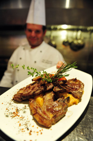 ASHKELON - JULY 27: Chef prepares delicious food in a restaurant on July 27 2009, in Ashkelon, Israel.のeditorial素材
