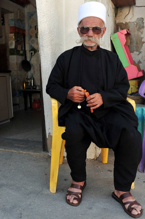 MAJDAL SHAMS - AUGUST 23:A Druze man sit outside his front door in Majdal Shams,Israel on August 23 2009.The number of Druze people worldwide exceeds one million, with the vast majority residing in the Middle East.のeditorial素材