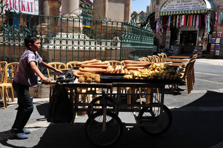 JERUSALEM - JULY 28: Arab boy sale Arab pretzels at Jerusalem old city market on July 28 2009.Jerusalem is a holy city to the three major Abrahamic religions:Judaism, Christianity and Islam.のeditorial素材