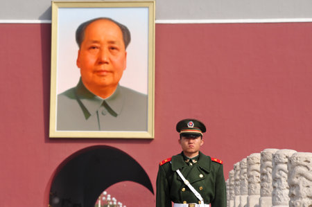 BEIJING - MARCH 11:Chinese soldier stands guard in front of a portrait of Mao Zedong in Tiananmen square on March 11 2009 in Beijing,China. Chairman Mao Zedong is still being worshiped all over China.のeditorial素材