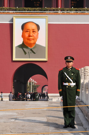 BEIJING - MARCH 11:Chinese soldier stands guard in front of a portrait of Mao Zedong in Tiananmen square on March 11 2009 in Beijing,China. Chairman Mao Zedong is still being worshiped all over China.のeditorial素材