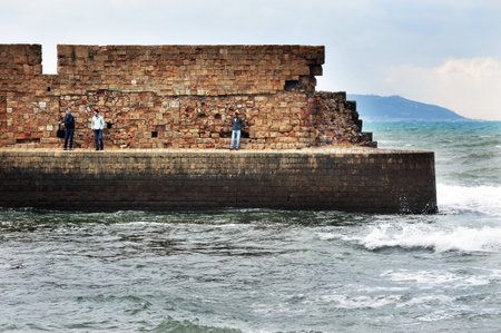 ACRE, ISR - DEC 13:Fishermen on Acre sea walls on Dec13 2009.Acre is one of the oldest continuously inhabited sites in Israel.のeditorial素材