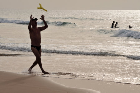 Silhouette of people at the beach.のeditorial素材