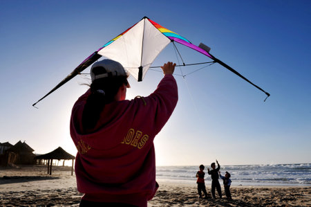 ASHDOD - DECEMBER 19:People flying a kite on the beach on December 19 2009 in Ashdod, Israel. Kite flying is one of the fastest growing sports in the woのeditorial素材