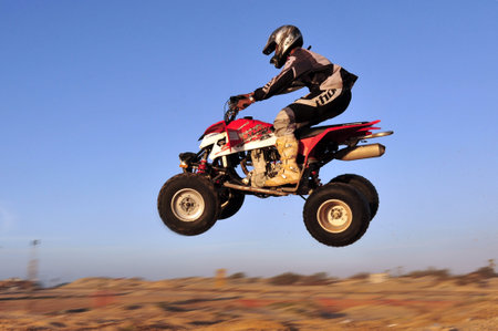 ASHDOD - DECEMBER 19:An ATV rider jumps with his Quad bike in the air on December 19 2009 in Ashdod,...