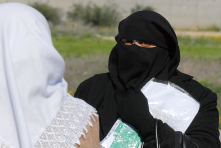 EREZ CROSSING, ISR - Muslim woman covered in burqa on Feb 11 2010.In some European countries It's illegal to wear a face-covering veil in public places such as:street, shops and public transportation.のeditorial素材
