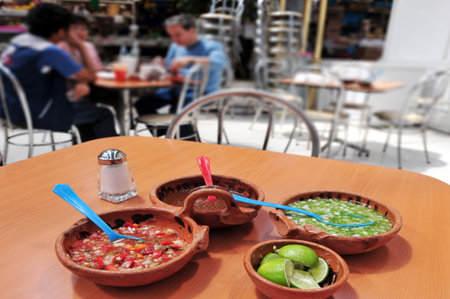 MEXICO CITY - MAR 02 2010:Mexican people eating hot chili and spicy mexican food.Mexican food is well-known for its exotic flavors and the use of strong spices.のeditorial素材