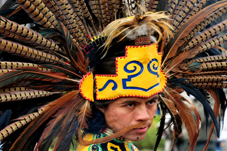 MEXICO CITY - FEB 23:Portrait of Male Aztec Indian wearing traditional clothing and headdressat the Zocalo Square on February 23 2010 in Mexico City.Since 1982 the ZÃ³calo become cultural events centerのeditorial素材
