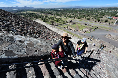 TEOTIHUCAN - FEB 26:Visitors climb to the top of the the Sun Pyramid on february 26 2010 in Teotihuacan, Mexico. It's the third largest pyramid in the world (738 feet/225m across and 246 feet/75m high)のeditorial素材