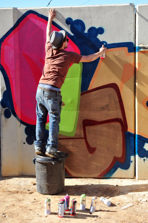 SDEROT - APRIL 26: An urban graffiti artist decorating a wall of security shelter on April 26 2010 in Sderot, Israel.It's  writing or drawings scribbled, scratched, or sprayed illicitly on a wall or other surface in a public placeのeditorial素材