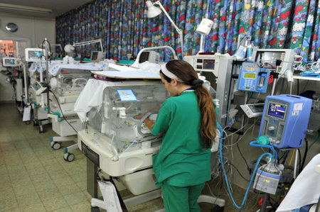 ASHKELON - MAY 07: Medical staff in the premature infants department on May 07 2010 at Barzilai hospital in Ashkelon, Israel.It's is the birth of a baby of less than 37 weeks gestational age.のeditorial素材