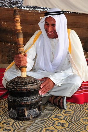WESTERN NEGEV - APRIL 07: A Bedouin man  grinds Coffee in his tent in the Negev desert, Israel on...