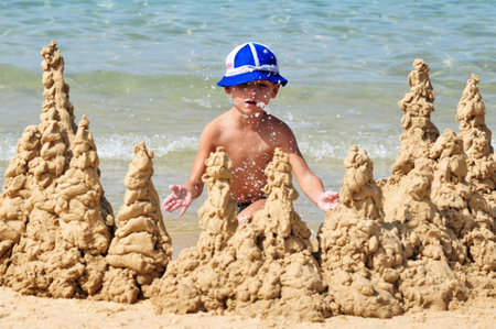 ASHKELON,ISR - OCT 16:little boy builds sand castle on Oct 16 2010.The population of children living in Israel numbered ABOUT of 2,500,000 children, constituting over 30% of the general population.のeditorial素材