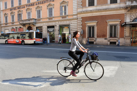 ROME - APR 28:Italian woman rids bicycle on April 28 2011 Rome, Italy.From May till September the historic center of Rome is closed to automobile every second Sunday to reduced air and noise pollutionのeditorial素材