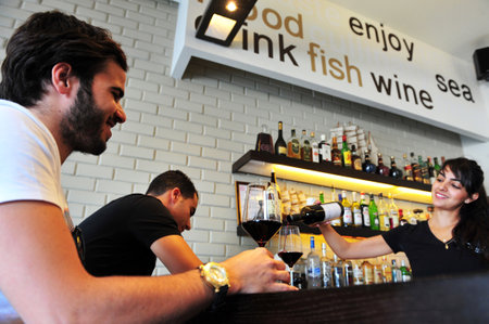 ASHDOD - MAY 03: Young Israeli people are drinking alcohol in a bar on May 03 2010 in Ashdod, Israel.のeditorial素材