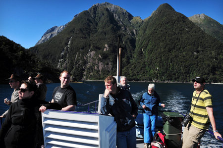 FIORDLAND, NZ- FEB 28:Tourist explores Milford Sound on February 28 2009.It's one of the most  beautiful parts of New Zealand and the largest of NZ national parks with an area of 12,500 km.のeditorial素材