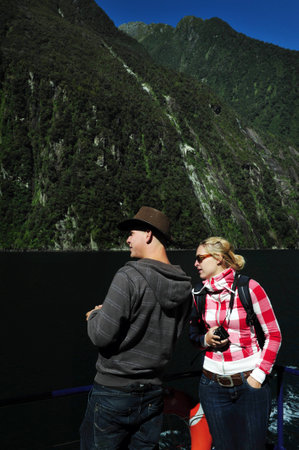 FIORDLAND, NZ- FEB 28:Tourist explores Milford Sound on February 28 2009.It's one of the most  beautiful parts of New Zealand and the largest of NZ national parks with an area of 12,500 km.のeditorial素材