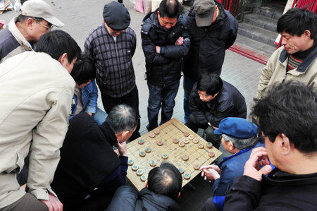 BEIJING - MAR 14:Chinese people play Xiangqi Chinese Chess in Beijing,China on March 14 2009.It's one of the most popular board game in the world, played by millions of people in China and Asia.のeditorial素材