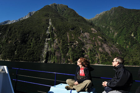 FIORDLAND, NZ- FEB 28:Tourist explores Milford Sound on February 28 2009.It's one of the most  beautiful parts of New Zealand and the largest of NZ national parks with an area of 12,500 km.のeditorial素材