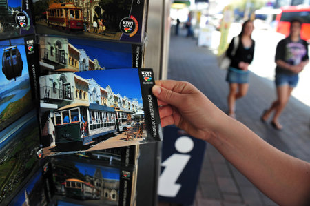 CHRISTCHURCH - FEB 27:Tourists buy a postcard of Christchurch Feb 27 2009,NZ. Christchurch was officially established on July 31, 1856, making it the oldest city in New Zealand.のeditorial素材