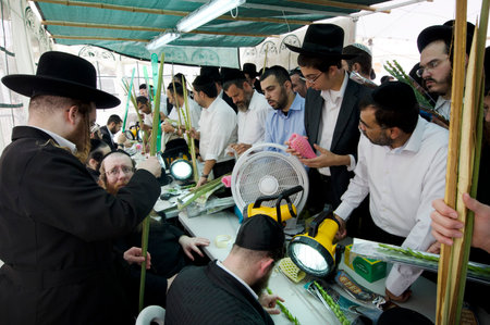 ASHDOD - OCTOBER 12 : Jewish ultra-orthodox  purchasing blessings at a four species market for the Jewish holiday of Sukkot on October 12 2011 in Ashdod,Israel.のeditorial素材