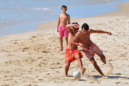 ASHDOD - JUNE 26: Young men playing soccer on the beach on June 18 2011 in Ashdod, Israel.    Soccer is the fastest growing and most popular sport in the world.のeditorial素材