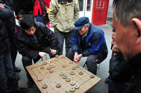 BEIJING - MAR 14:Chinese people play Xiangqi Chinese Chess in Beijing,China on March 14 2009.It's one of the most popular board game in the world, played by millions of people in China and Asia.のeditorial素材