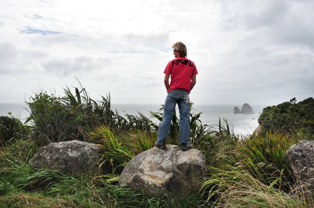 WEST COAST, NZ - APRIL 19:Tourist on a west coast overlook point on April 19 2009.The West Coast has been numbered among the 'Top 10 Coastal Drives of the World' by Lonely Planet.のeditorial素材