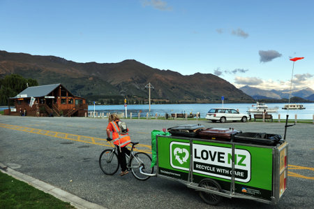 WANAKA,NZ - MAR 03:Recycling bin pulled by a biker at Lake Wanaka on March 02 2009.It's New Zealand's fourth largest lake and estimated to be more than 300 m 980 ft deep.のeditorial素材