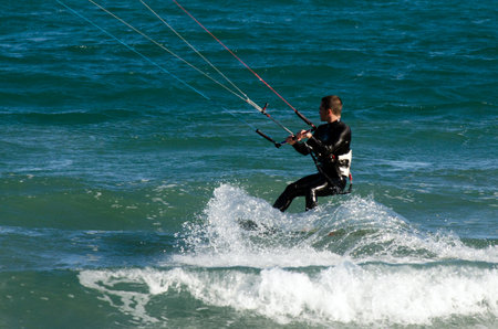 WELLINGTON - FEB 23: Man Kitesurfing on February 23 2013 in Lyall  Bay, Wellington New Zealand. In 2012, the number of kitesurfers estimated to 1.5 million persons world wide.のeditorial素材