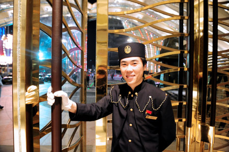MACAU - FEB 20:Bellboy of Grand Casino Lisboa on February 20 2009 in Macau, China.Gambling in Macau has been legal since the 1850s when the Portuguese government legalised the activity in the colony.のeditorial素材