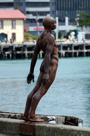 WELLINGTON - FEB 21:The famous Solace of the Wind statue which leans over the edge of the pier on the Wellington waterfront near the Oriental Bay marina on February 24 2013.のeditorial素材
