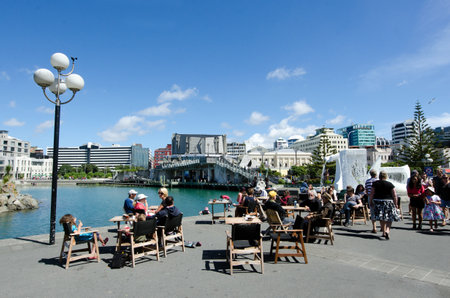 WELLINGTON - FEB 24:Visitors at Wellington waterfront lagoon,historic Star Boating Club 1885, Wellington Rowing Club 1894 and Wharewaka o Poneke building on February 24 2013 in Wellington,NZ.のeditorial素材