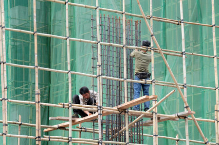MACAU - FEB 20: Chinese builders builds new Casino on February 20 2009 in Macau, China. Gambling tourism is Macau's biggest source of revenue, making up about 50 of the economy.のeditorial素材