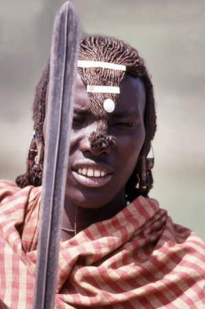 MASAI MARA- DECEMBER 20: Maasai warrior in their village in aasai Mara National Reserve in Kenya, Africa on December 20 1989. For Maasai living a traditional life, the end of life is virtually without ceremony, and the dead are left out for scavengers.のeditorial素材