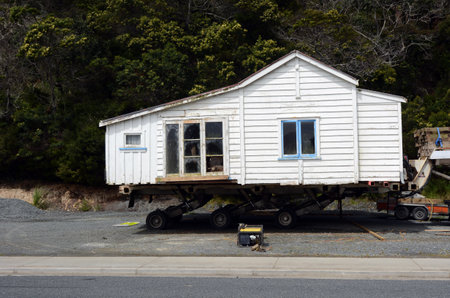 MANGONUE, NZ - OCT 05:Transporting an old house to a new location on Oct 05 2013.The cost of buying an old house for removal can range from a few thousand dollars to over 100,000 for a large home.のeditorial素材