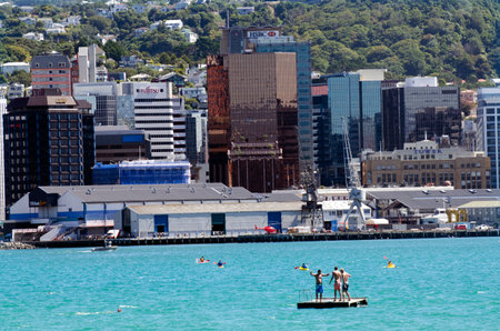 WELLINGTON - FEB 28:Swimmers on wooden barg against Wellington downtown on February 28 2013 in Wellington, New Zealand. It's the capital city and second most populous urban area of New Zealand.のeditorial素材