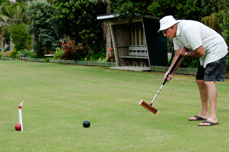 TAIPA  - NOVEMBER 28: Croquet player plays Croquet in Taipa club in Northland, New Zealand on November 28, 2012. Croquet was the first outdoor sport to embrace equality, allowing both sexes to play the game on an equal footing.のeditorial素材