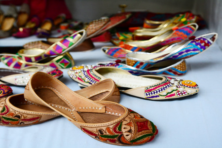 Colorful indian ethnic shoes on flea market in India. copy space