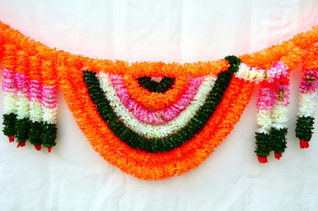 Indian festive decoration - a garland of orange and yellow Marigold (Tagetes) flowers.Background and texture with copy spaceの写真素材