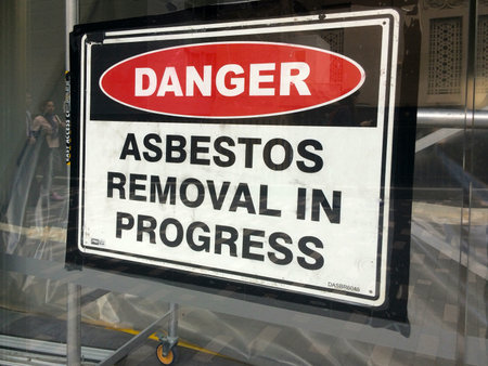 AUCKLAND - AUG 01 2015:Sign reads: Danger - Asbestos removal in progress.Inhalation of asbestos fibers can cause serious and fatal illnesses including lung cancer, mesothelioma and asbestosis.のeditorial素材