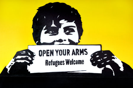 AUCKLAND, NZL - NOV 20 2015: Graffiti with the political slogan "Refugees Welcome".Each year New Zealand accepts 750 refugees as agreement with the United Nations High Commissioner for Refugees.のeditorial素材