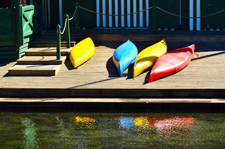 Colourful kayaks on a wooden pier. Summer vacation conceptの写真素材